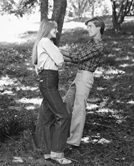 <b class=qtipBold><figcaption>Young couple standing by a tree</figcaption></b> Young couple standing by a tree
