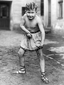 <b class=qtipBold><figcaption>A Youthfull Strongman</figcaption></b><br>Germany: 1929. The son of a German strongman. the boy can break a chain and drive a nail with his fist.<br><em>© Underwood Archives/UIG</em> A Youthfull Strongman