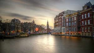 Amstel river and Munttoren Amsterdam sunset view Amstel river and Munttoren Amsterdam sunset view