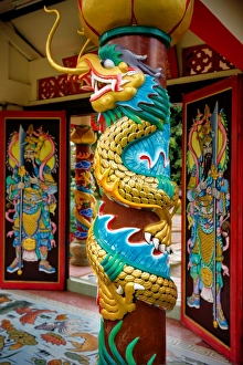 A Dragon Carving on a Pillar in Wat Hainan Temple Nathon, Ko Samui District, Surat Thani A Dragon Carving on a Pillar in Wat Hainan Temple Nathon, Ko Samui District, Surat Thani