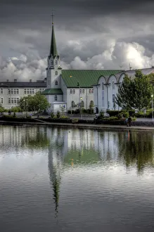 Frikirkjan church Tjornin lake cloudy reflections Frikirkjan church Tjornin lake cloudy reflections