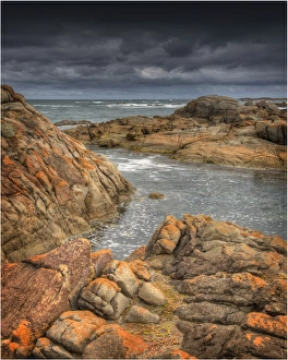 Half moon bay on the West coastline of King Island, has large rock-pools and magnificent red coloured lichen boulders Half moon bay on the West coastline of King Island, has large rock-pools and magnificent red coloured lichen boulders