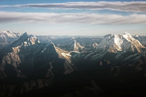 High Himalayas snow covered peaks view from plane High Himalayas snow covered peaks view from plane