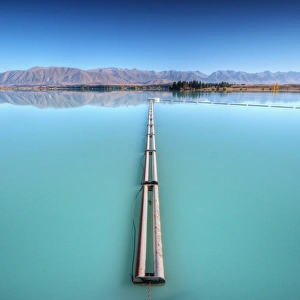 <b class=qtipBold><figcaption>Lake Ruataniwha</figcaption></b><br>Pipeline across lake Ruataniwha with mountain reflection on lake in Mackenzie Basin, Twizel, New Zealand.<br><em>© 2010 :: Artie | Photography ::</em> Lake Ruataniwha