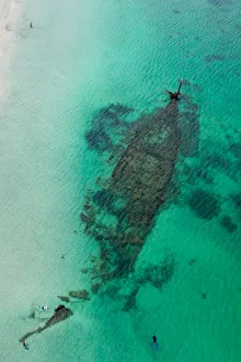 people snorkeling around a shipwreck people snorkeling around a shipwreck