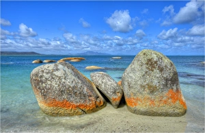 Red coloured boulders at Sawyers bay, caused by lichen growing at the high tide mark on Flinders Island, Bass Strait Red coloured boulders at Sawyers bay, caused by lichen growing at the high tide mark on Flinders Island, Bass Strait