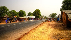 Road market in rural Gambia with colourful stalls, clear sky and no cars Road market in rural Gambia with colourful stalls, clear sky and no cars