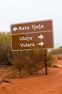 Road sign next to a sandy outback track Road sign next to a sandy outback track