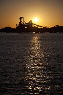 Silhouette of a bucket wheel reclaimer at an iron ore mine Silhouette of a bucket wheel reclaimer at an iron ore mine