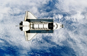 Space shuttle orbiting earth, satellite view Space shuttle orbiting earth, satellite view