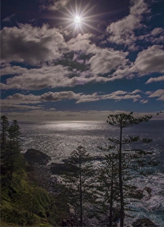 Sunstar and clouds along the Norfolk Island coastline Sunstar and clouds along the Norfolk Island coastline