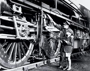 Images Dated 27th February 2003: An engine driver explaining the valve gear to a schoolboy. This is the London Midland and Scottish