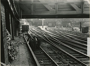 Liverpool Street station, East, about 1911. Taken from the coal stage close to Primrose Street bridge, platform 18 beyond coal wagon. There is a raised water tank at end of platform. Members of Great Eastern Railway staff are holding an impromptu meeting in the foreground, with a foreman wearing a bowler hat. A main line train stands at platform 11 on extreme right Liverpool Street station, East, about 1911
