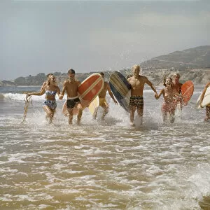 1960s Surfers Running in the Water