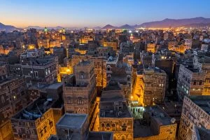 Illuminated Gallery: Aerial view of Sanaa cityscape at twilight, Yemen