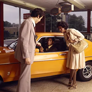 African-American Couple Buy New Orange Car From A Salesman At Automobile Dealer Showroom African-American Couple Buy New Orange Car From A Salesman At Automobile Dealer Showroom