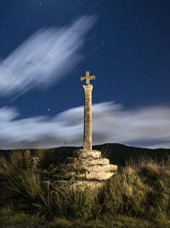 Ancient monument of medieval epoch in the shape of cross, illuminated by the moonlight Ancient monument of medieval epoch in the shape of cross, illuminated by the moonlight