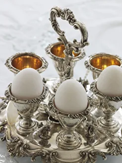 Antique silver egg cups in a sophisticated environment Antique silver egg cups in a sophisticated environment