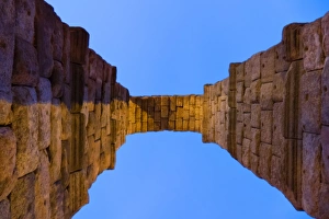 An Arch of Aqueduct of Segovia against blue sky An Arch of Aqueduct of Segovia against blue sky