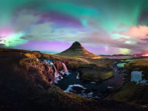 Aurora borealis dancing above the signature mountain snaefellnes kirkjufell in winter Aurora borealis dancing above the signature mountain snaefellnes kirkjufell in winter
