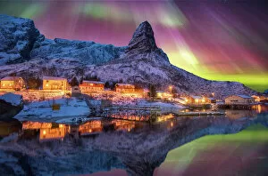 Nordic Gallery: Aurora borealis above snowy islands of Lofoten