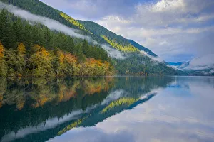 Autumn forest reflecting in Crescent Lake, Olympic National Park, Washington State, USA Autumn forest reflecting in Crescent Lake, Olympic National Park, Washington State, USA