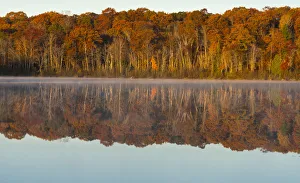 Autumn forest reflecting in Mill Pond Lake, Wisconsin, USA Autumn forest reflecting in Mill Pond Lake, Wisconsin, USA