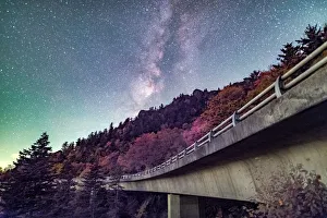 <b class=qtipBold><figcaption>Autumn Glow at the Linn Cove Viaduct</figcaption></b><br>Autumn at the Linn Cove Viaduct located off the Blue Ridge Parkway below the Milky Way Galaxy.<br><em>© ROBERT LOE</em> Autumn Glow at the Linn Cove Viaduct
