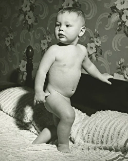 Baby (12-15 months) standing on bed, (B&W) Baby (12-15 months) standing on bed, (B&W)