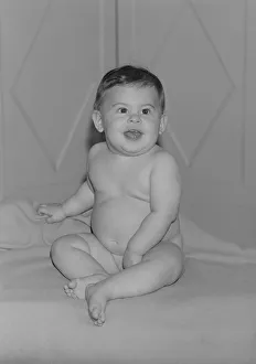 Baby girl (6-11 months) sitting on bed and laughing Baby girl (6-11 months) sitting on bed and laughing