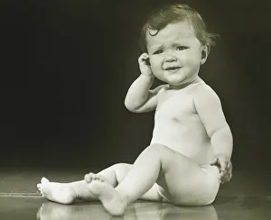 Baby girl (9-12 months) sitting on floor in studio, (B&W) Baby girl (9-12 months) sitting on floor in studio, (B&W)