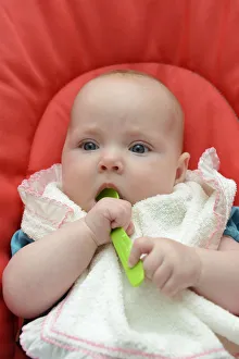 Baby, girl, six months, with spoon in her mouth, Germany Baby, girl, six months, with spoon in her mouth, Germany