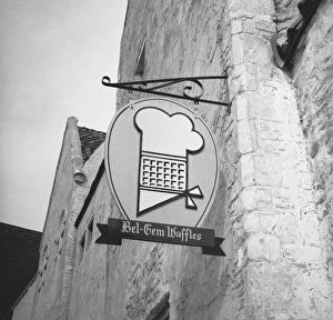 Bakery sign hanging on wall, (B&W), low angle view Bakery sign hanging on wall, (B&W), low angle view