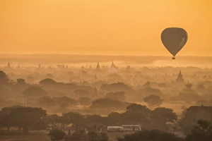 <b class=qtipBold><figcaption>Balloon flying over Bagan, Myanmar</figcaption></b><br>The misty landscape of The Bagan Archaeological zone (Unesco Heritage Site) with silhouttes of hot air balloons and ancient pagoda at sunrise.<br><em>© Theerayoot Tapina</em> Balloon flying over Bagan, Myanmar