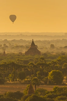 <b class=qtipBold><figcaption>Balloons flying over Bagan, Myanmar</figcaption></b><br>The misty landscape of The Bagan Archaeological zone (Unesco Heritage Site) with silhouttes of hot air balloons and ancient pagoda at sunrise.<br><em>© Theerayoot Tapina</em> Balloons flying over Bagan, Myanmar
