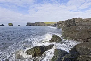 Basalt cliffs and a rock arch on the coast, Dyrholaey, Vik i Myrdal, Southern Region Basalt cliffs and a rock arch on the coast, Dyrholaey, Vik i Myrdal, Southern Region