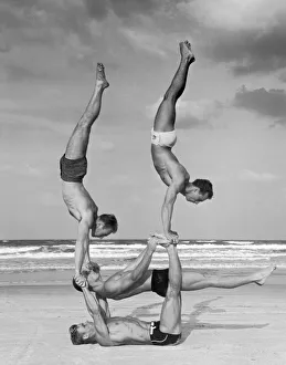 <b class=qtipBold><figcaption>Beach Balance</figcaption></b><br>Lifeguards performing acrobatics at Daytona Beach, Florida, circa 1940.<br><em>© FPG</em> Beach Balance