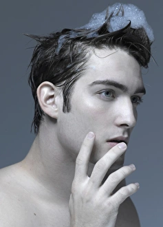 Beauty portrait of a young man washing his hair Beauty portrait of a young man washing his hair