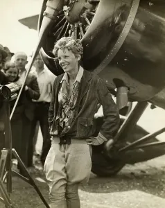 Prints of Amelia Earhart (1898-1937), American aviator, smiling as she stands near her plane Pioneer Prints: Amelia Earhart Beside Her Plane Print