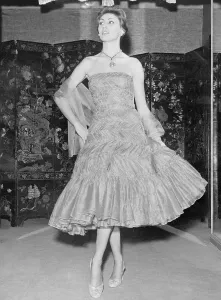 Prints of (Original Caption). Shown is a creation from the 1957-58 Autumn-Winter collection of Gabrielle Chanel of Paris. It is a short length evening dress in apricot chiffon Fashion Prints: Coco Chanel 1957-58 Apricot Chiffon Evening Dress Print