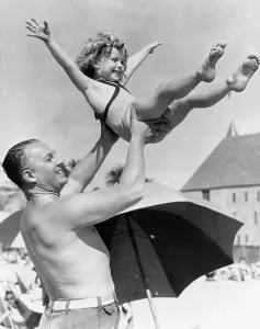 Shirley Temple Prints: Shirley Temple with Father at Santa Monica Beach Print