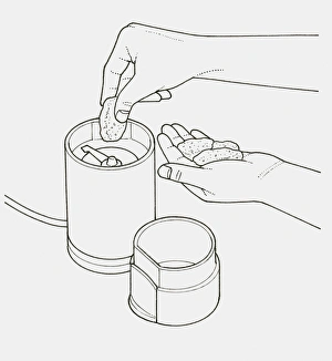 Black and white illustration of putting nut in grinder Black and white illustration of putting nut in grinder