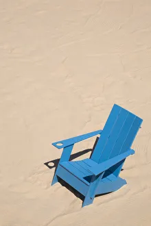 Blue adirondack chair standing on a beach, Old Port of Montreal, Quebec Province, Canada Blue adirondack chair standing on a beach, Old Port of Montreal, Quebec Province, Canada