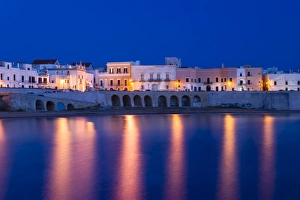 Blue hour, dusk, Seno della Purita city beach, historic centre with the church Chiesa della Purita, Gallipoli Blue hour, dusk, Seno della Purita city beach, historic centre with the church Chiesa della Purita, Gallipoli