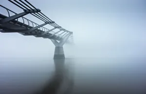 <b class=qtipBold><figcaption>Out of the Blue, London</figcaption></b><br>Millennium Footbridge crossing the River Thames in London UK, early morning in thick dense fog, long exposure photography<br><em>© Vulture Labs</em> Out of the Blue, London
