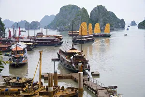 Boats and rocky islands in Vietnamese harbor Boats and rocky islands in Vietnamese harbor