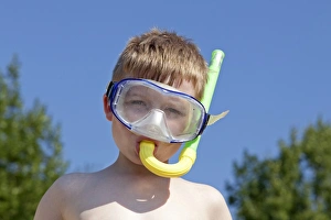 Boy with diving mask and snorkel, near Donja Klada, Kvarner Gulf, Croatia Boy with diving mask and snorkel, near Donja Klada, Kvarner Gulf, Croatia