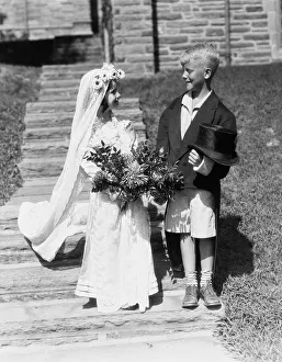 Boy and girl dressed up as bride and groom, outdoors on steps Boy and girl dressed up as bride and groom, outdoors on steps