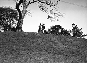 Two boys (10-11) flying kite on hill, (rear view), (B&W) Two boys (10-11) flying kite on hill, (rear view), (B&W)