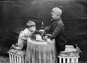 <b class=qtipBold><figcaption>Two Boys Smoking</figcaption></b><br>Two young boys kneel on stools on either side of a round table as one uses a match to this the other's cigarette, November 12, 1928. (Photo by FPG/Getty Images)<br><em>© 2004 Getty Images</em> Two Boys Smoking